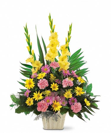 Yellow and pink floral arrangement in a square vase