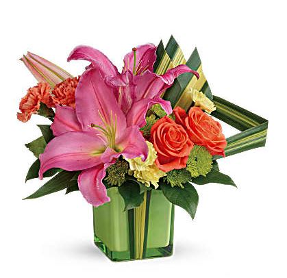 Color Me Cute - Color them happy when this cute cube arrives! Glorious pink lilies and orange roses get a modern, tropical twist with the addition of dramatic hala leaves. A bright touch for any occasion! Orange roses, hot pink oriental lilies, orange carnations, miniature yellow carnations, and green cushion spray chrysanthemums are accented with hala leaf and lemon leaf. Delivered in Teleflora's Leaf Color Splash cube while supplies last. 