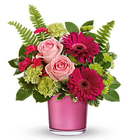Pink roses and magenta daisies in a pink glass vase