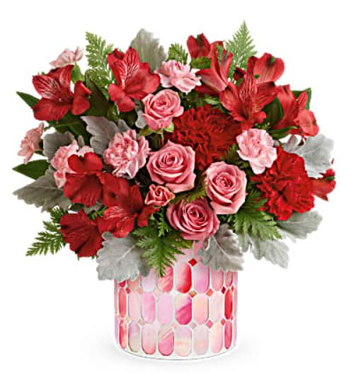 Precious in Pink - Everyone's crushing on this precious Valentine's Day gift! Bursting with classic red and pink blooms, this magnificent mosaic vase of pink stained glass is sure to make her heart flutter. This bouquet includes pink spray roses, red alstroemeria, red carnations, miniature pink carnations, dusty miller and leatherleaf fern. Delivered in Teleflora's Precious in Pink cylinder while supplies last.