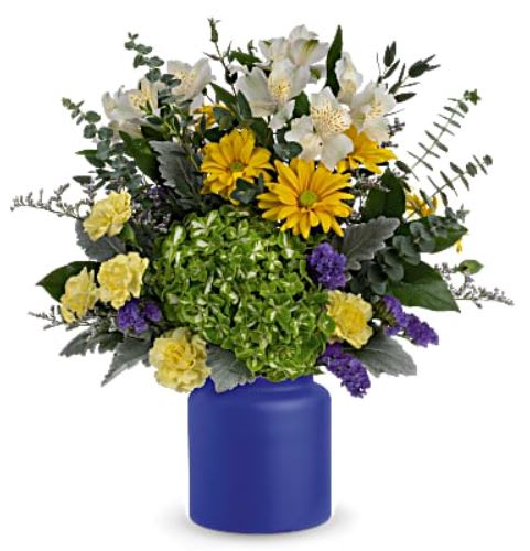 Sunrise at Sea Bouquet - Capture the magic of a sunrise at sea with this radiant white and yellow bouquet, arranged in a frosted glass vase the color of the deep ocean. This bouquet features green hydrangea, yellow daisy spray chrysanthemums, white alstroemeria, purple sinuata statice, light yellow miniature carnations, spiral eucalyptus, lemon leaf and dusty miller. Delivered in Teleflora's Savannah Jar.