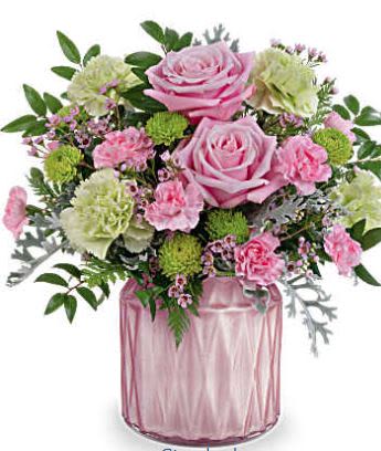 Sparkling Reverie - Brighten any moment with Teleflora's Dazzling Gem jar, its soft pearlescent shimmer perfectly complementing a delicate bouquet of soft pink and green blooms-a timeless expression of artistic beauty for any occasion. Teleflora's Sparkling Reverie Bouquet features a charming blend of pink roses, green carnations, pink miniature carnations, green button spray chrysanthemums, pink waxflower, silver lace dusty miller, huckleberry, and leatherleaf fern. Arranged in a pink pearlescent vase, this elegant bouquet adds a touch of timeless beauty to any space. 