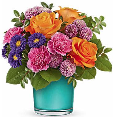 Bouquet of orange roses, pink carnations, and purple daisies in a blue vase