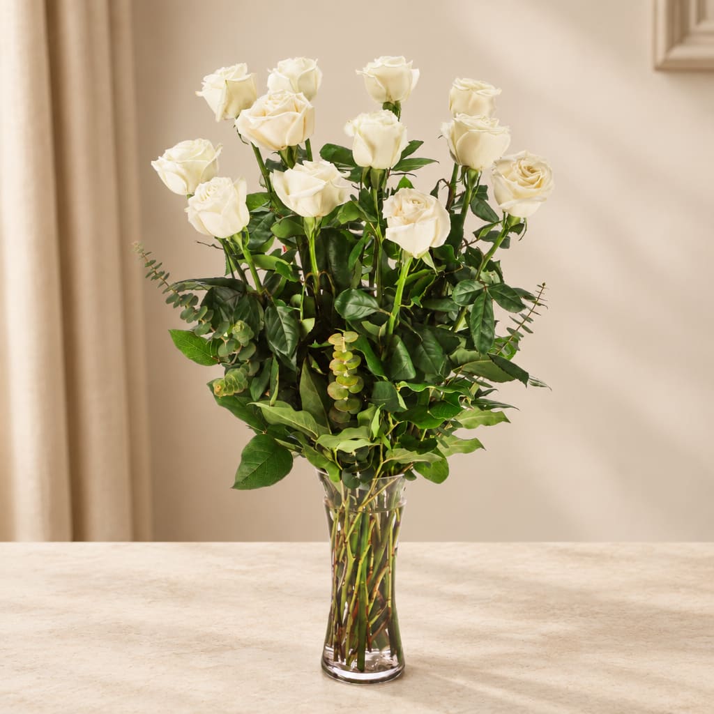 White roses arranged in a clear glass vase