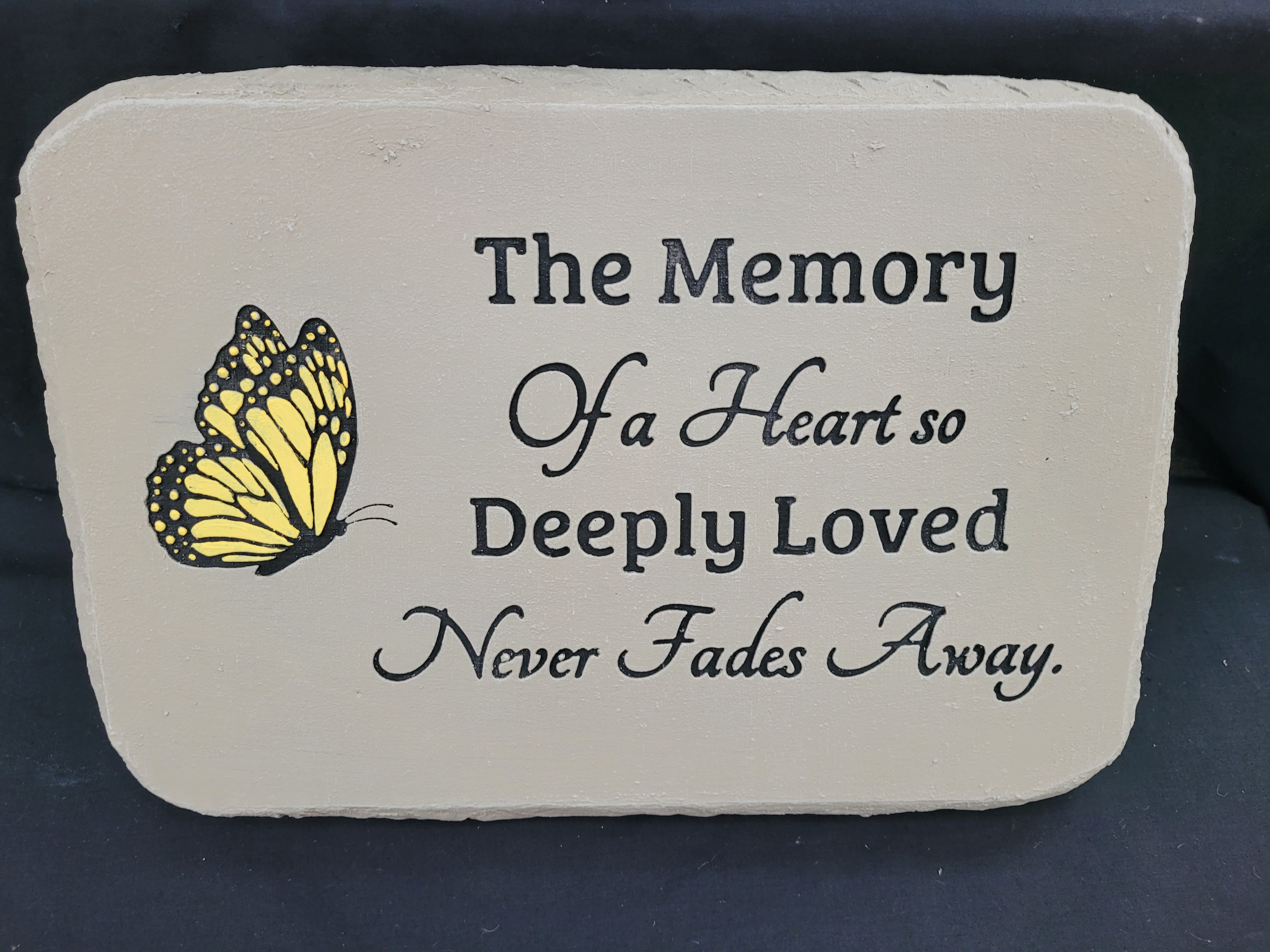 Memorial plaque with a yellow butterfly and remembrance text