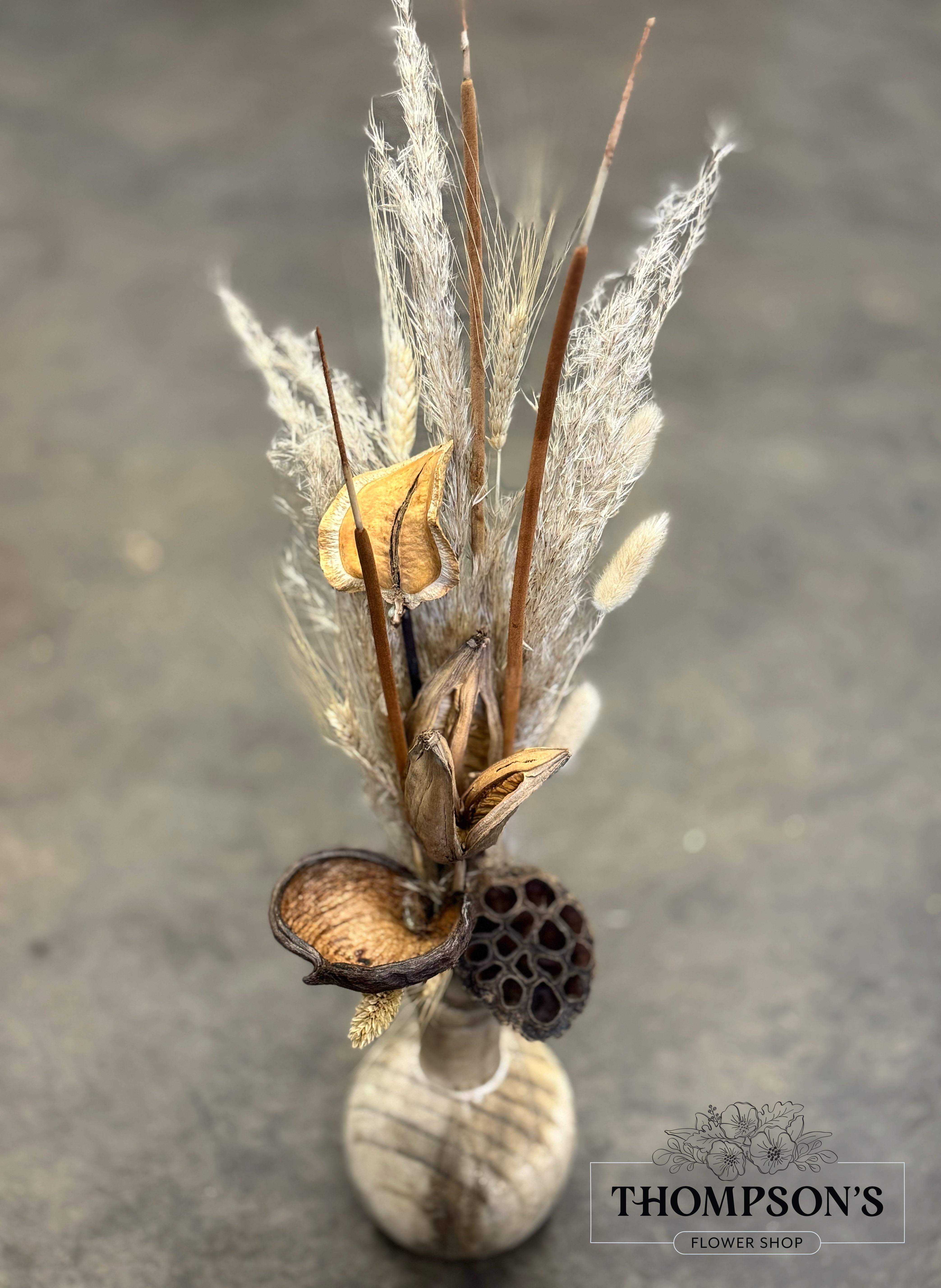 Preserved No. 1 - A soft mix of natural textures and preserved elements in a small wooden vase. This arrangement offers long-lasting style in a compact size, perfect for a bedside table, bathroom nook, or desktop refresh.