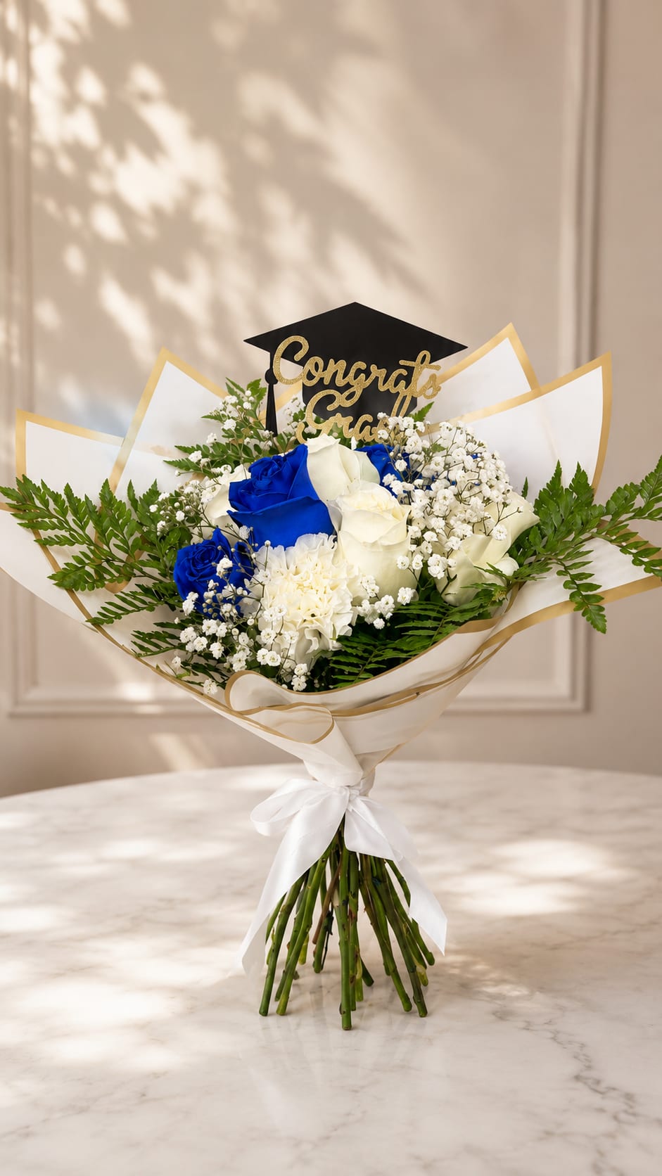Bouquet of blue and white roses with a graduation topper