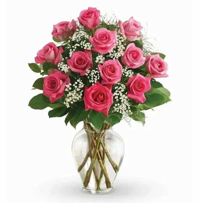 Pink roses arranged in a clear glass vase with baby's breath