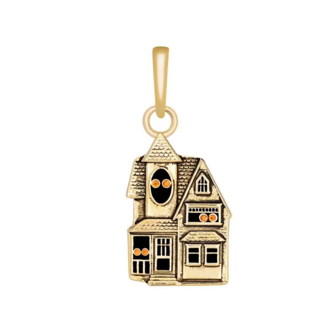 Gold house-shaped charm with orange accents on a white background