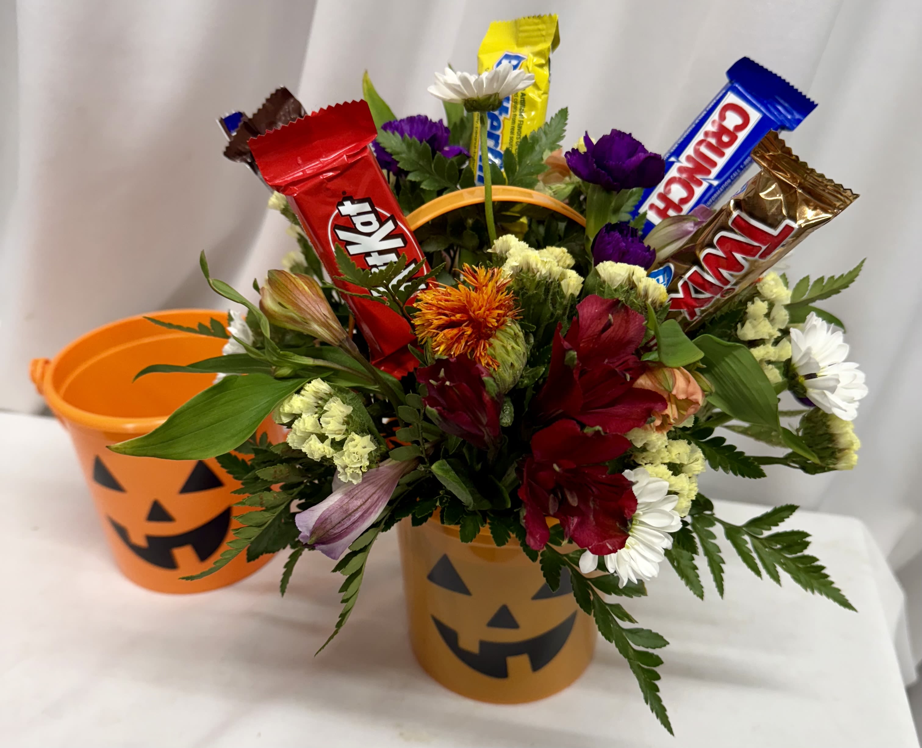 Halloween Treats! - Cute 4 inch plastic pumpkin pail filled with assorted seasonal blooms and some candy