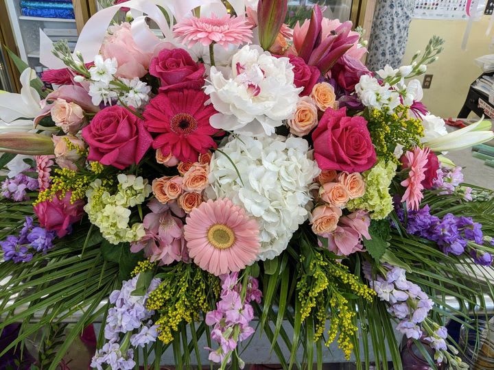 Large bouquet of pink, white, and purple flowers with lilies and roses