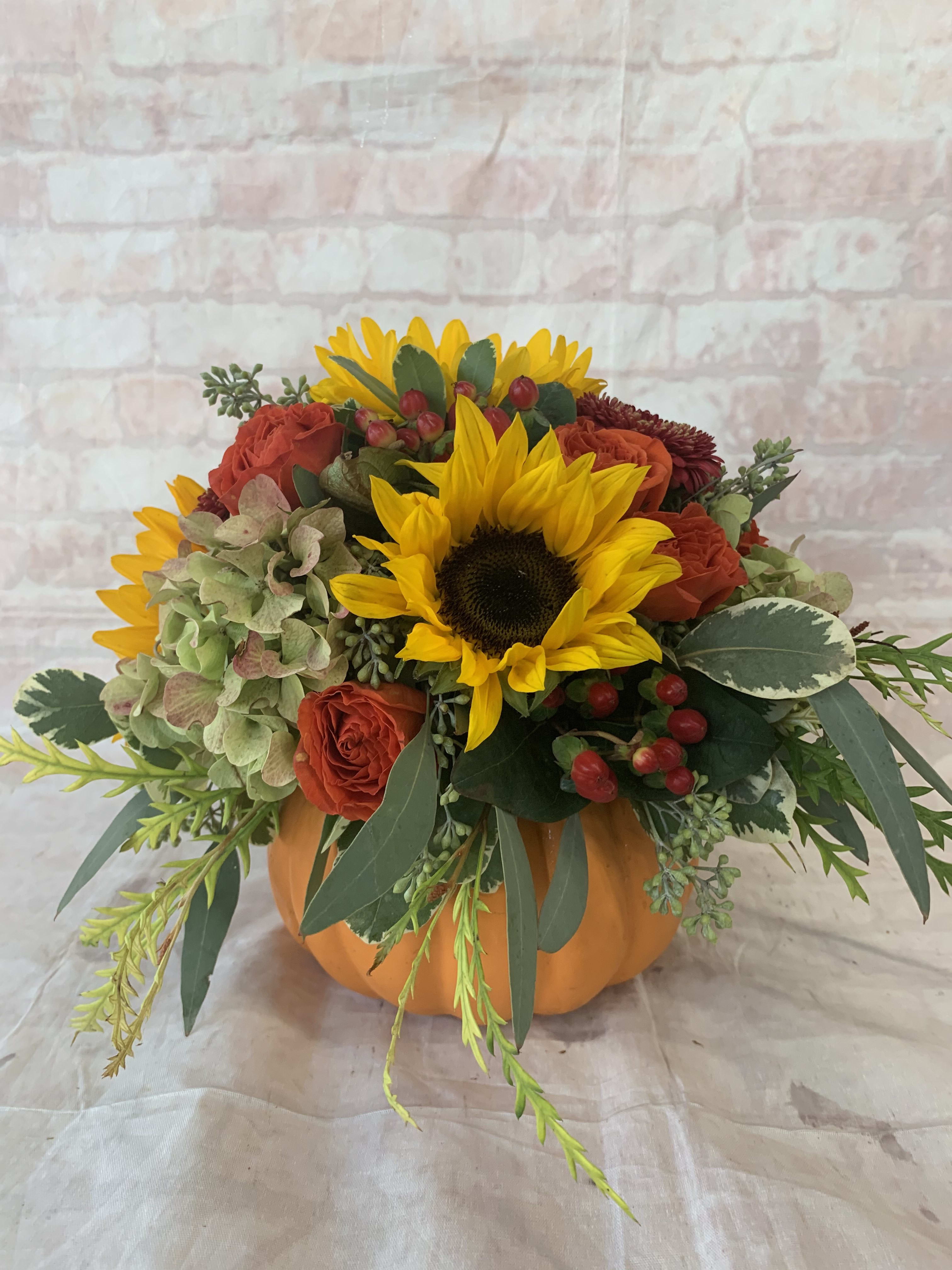 Autumn Gold - Select this bright arrangement that includes sunflowers, hydrangea, spray roses, hypericum and more in a pumpkin container. 