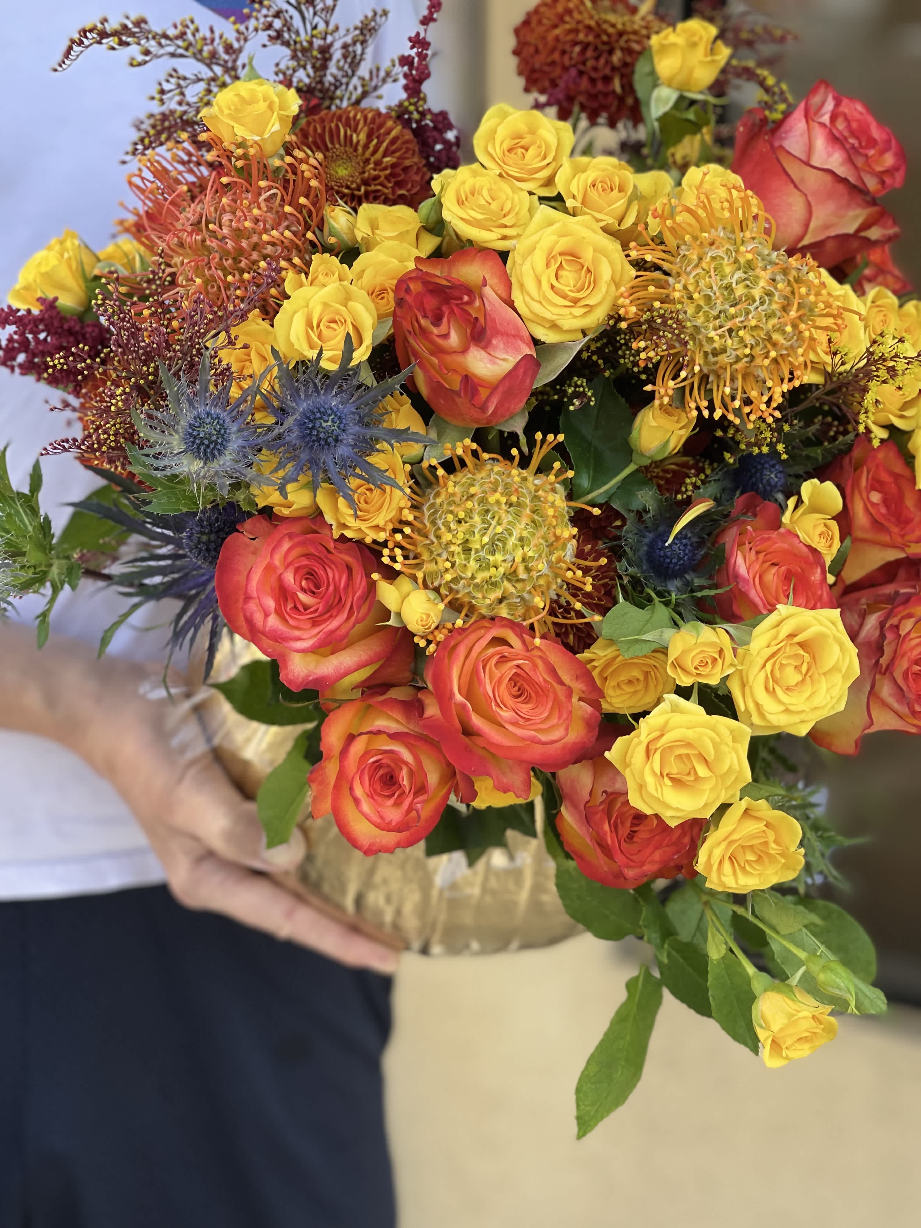 Seasonal Pumpkin! - Send fall cheer with our special seasonal gourd. Fresh flowers, including pin cushions, roses, spray roses, tinted leaves, freesia, eucalyptus and more in this gorgeous design. 