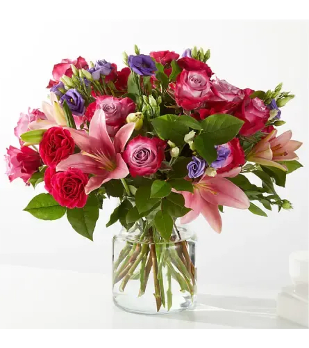Instant Cheer - Instant Cheer is a bold, happy mix of vibrant pinks and rich purples designed to brighten any room the moment it arrives.   Lush blooms are thoughtfully arranged with fresh greenery to create a look that feels fun, confident, and full of positive energy.   Perfect for celebrations, pick-me-ups, or sending a big smile just because, this arrangement delivers exactly what the name promises—cheer.