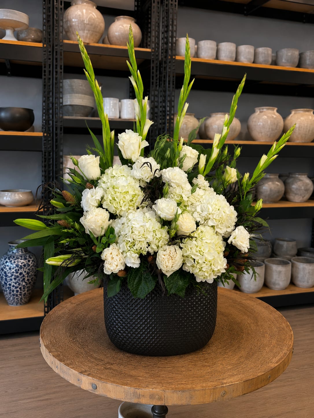 White floral arrangement in a black textured vase