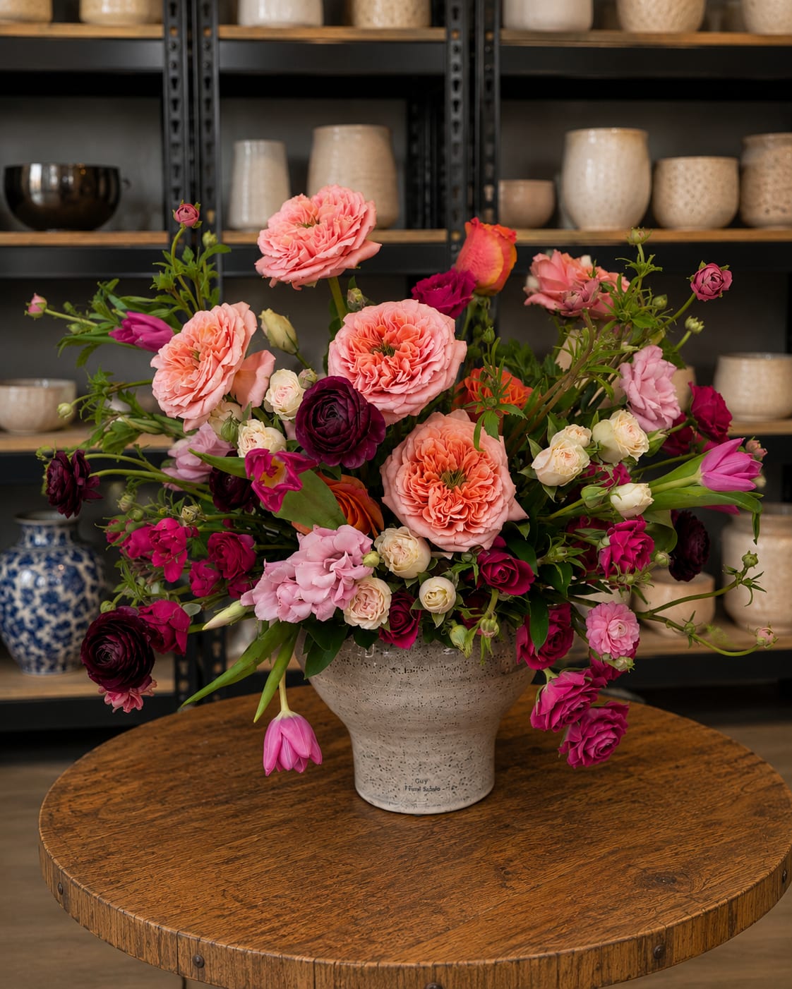 Mixed pink and magenta flowers arranged in a ceramic vase