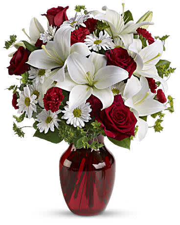  Be My Love Bouquet - Add some romance to the holiday season with this rich arrangement of luxurious flowers in classic winter colors. Red roses, snow white lilies and playful daisies are gathered in a ruby red vase she'll use well beyond Valentine's day. •Red roses, white asiatic lilies, white daisy spray chrysanthemums, mini red carnations and sprigs ofgreenery presented in a graceful red glass vase. •Orientation: One-Sided