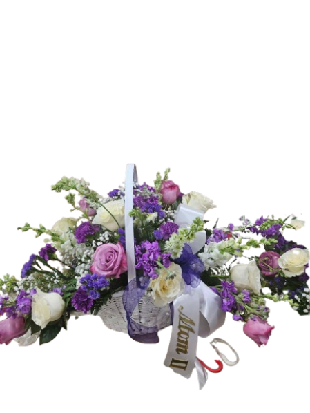 Lavender Grace Tribute Basket - A soft and elegant expression of sympathy, the Lavender Grace Tribute Basket offers comfort and beauty during life’s most difficult moments. Designed in a classic handled basket, this arrangement features a soothing blend of lavender, purple, blush, and white blooms—symbolizing peace, remembrance, and heartfelt love.  Delicate roses, seasonal florals, and airy greenery are artfully arranged to create a graceful, garden-inspired display that feels both full and refined. The natural basket adds warmth and tradition, making it a timeless choice for funeral services, memorials, or sending comfort to the home.  This piece is thoughtfully designed to honor a loved one while bringing a sense of calm and serenity to those who receive it.  Specialty Ribbon $10.00 additional