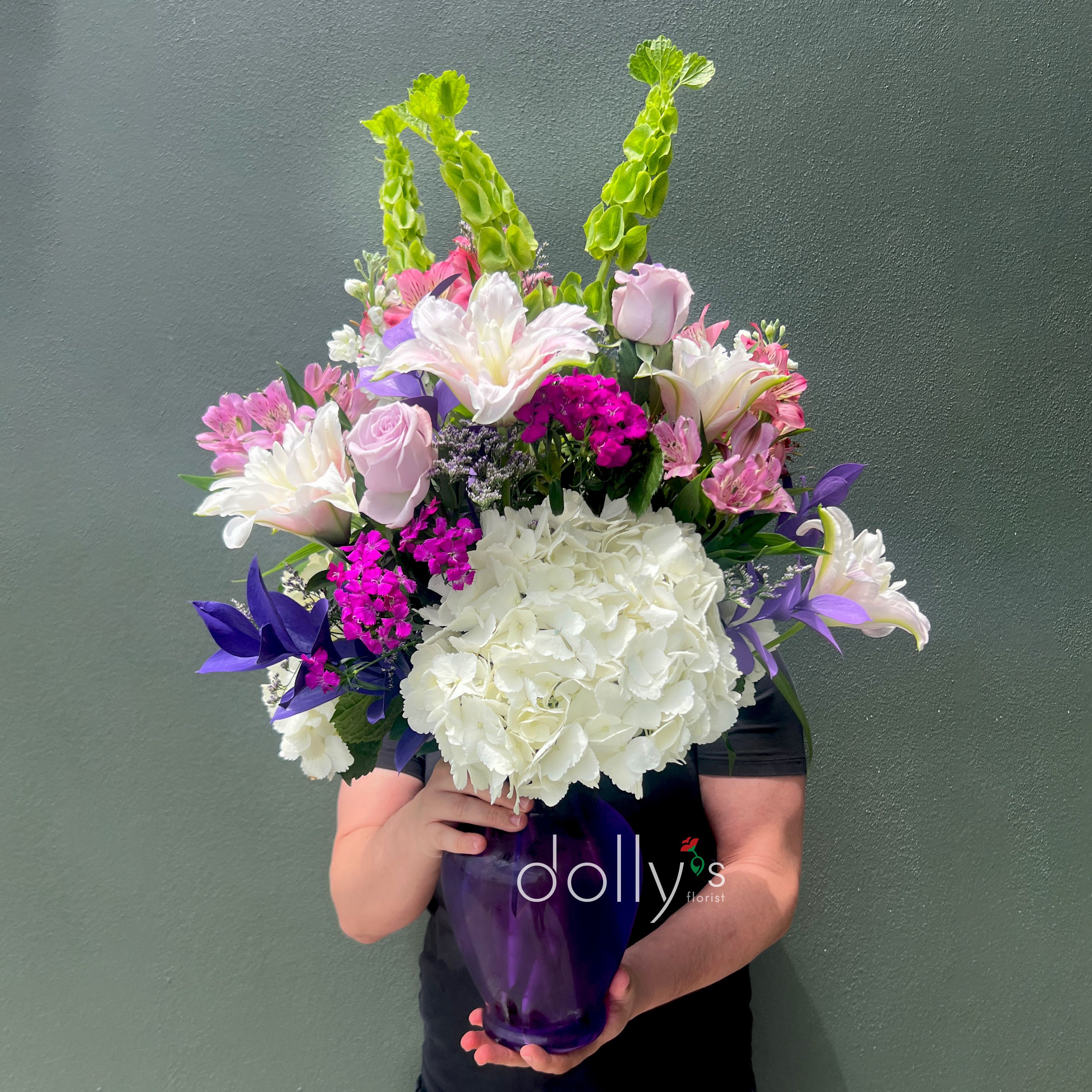 Purple Passion - A tall, garden‑fresh bouquet that catches the eye with its purple and pink drama-perfect as a birthday bouquet, a Mother's Day gift, or a "just because" surprise that reads as both romantic and celebratory. Purple Passion places the flower arrangement and occasion up front: lavender roses and pale lilies mingle with bright pink alstroemeria and spray roses so the person you're thinking of will feel genuinely celebrated the moment the vase arrives.  Ideal for birthdays, anniversaries, Valentine's Day, or a thoughtful Mother's Day gesture, Purple Passion suits anyone who appreciates a stylish, garden-inspired statement. 