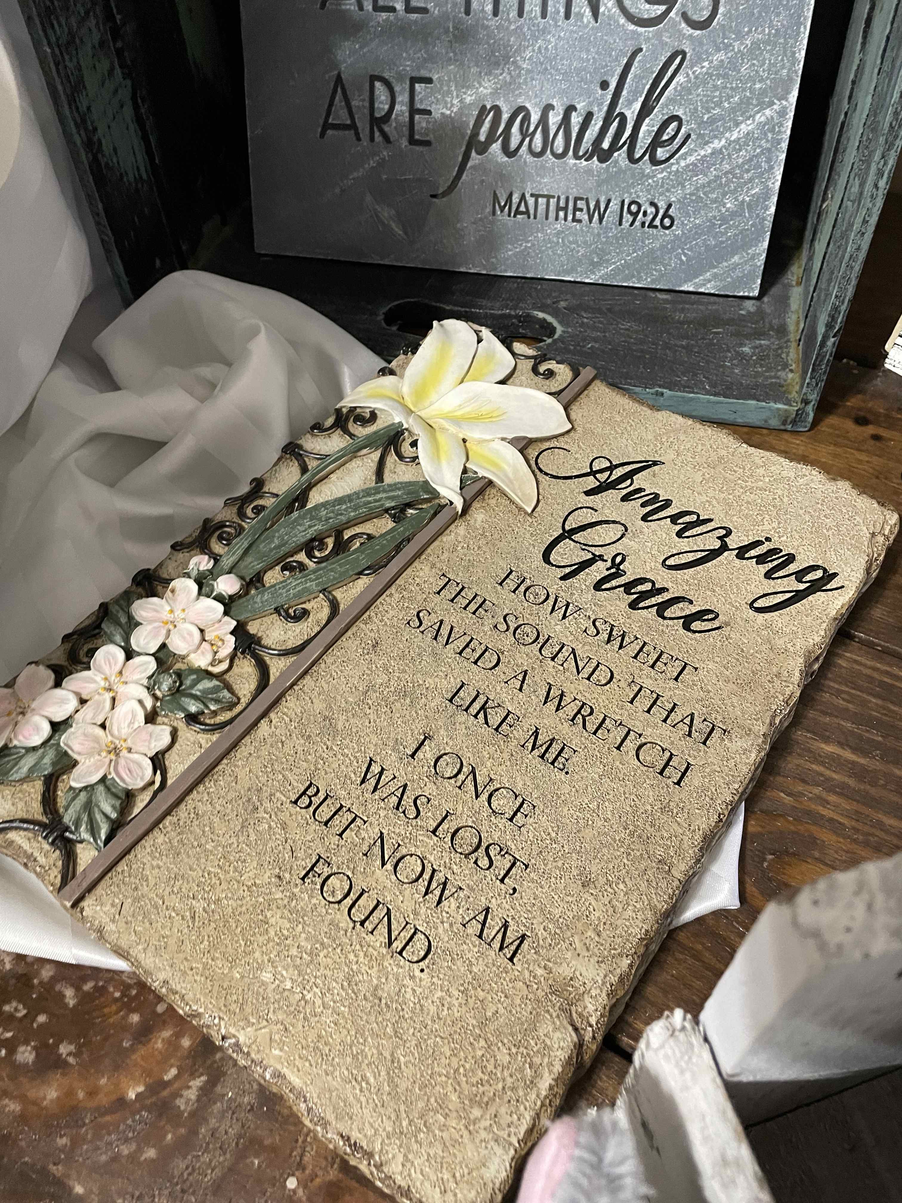 Decorative plaque with white flowers and a Bible verse