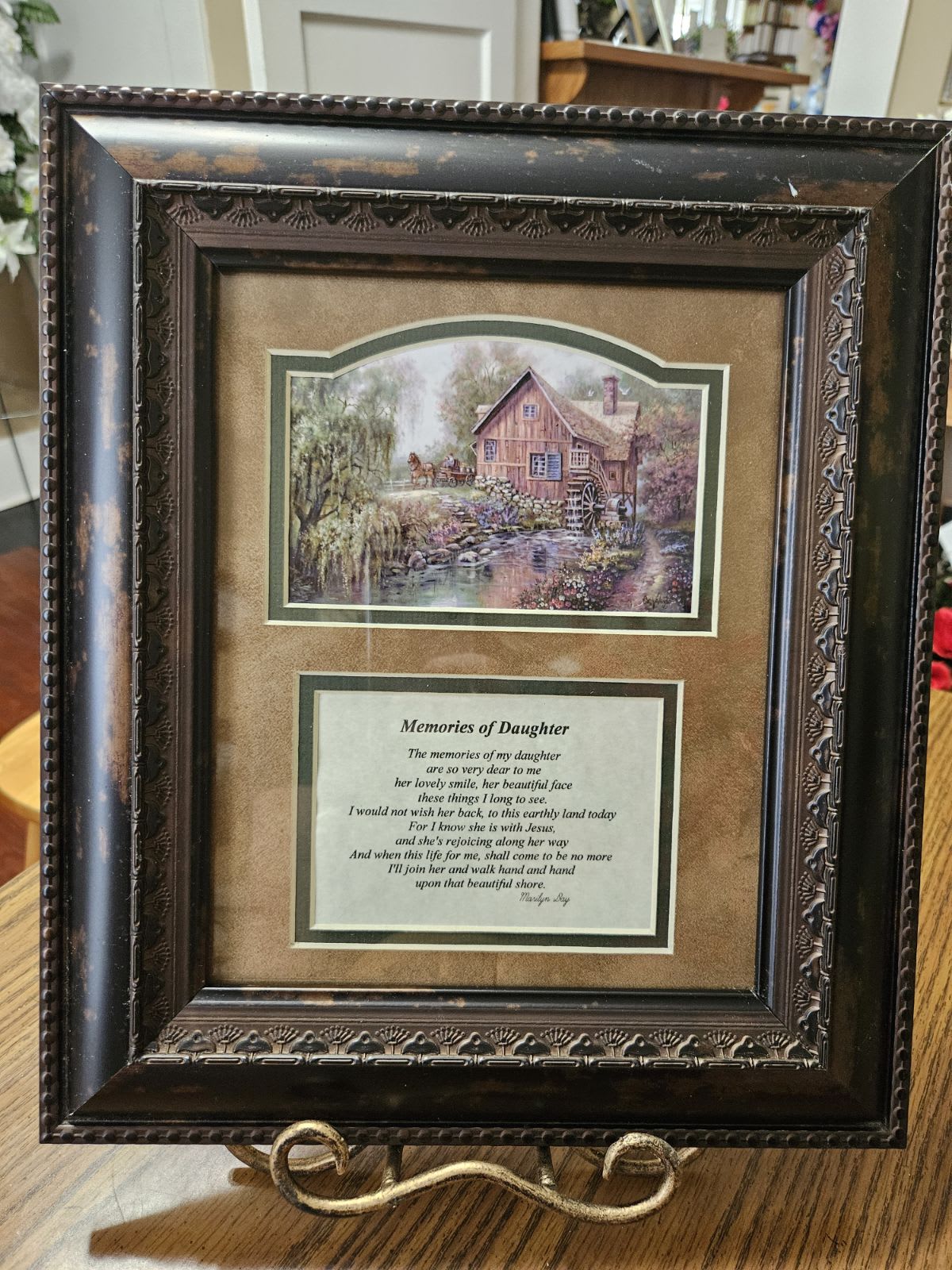 Framed memorial plaque with a countryside scene and poem