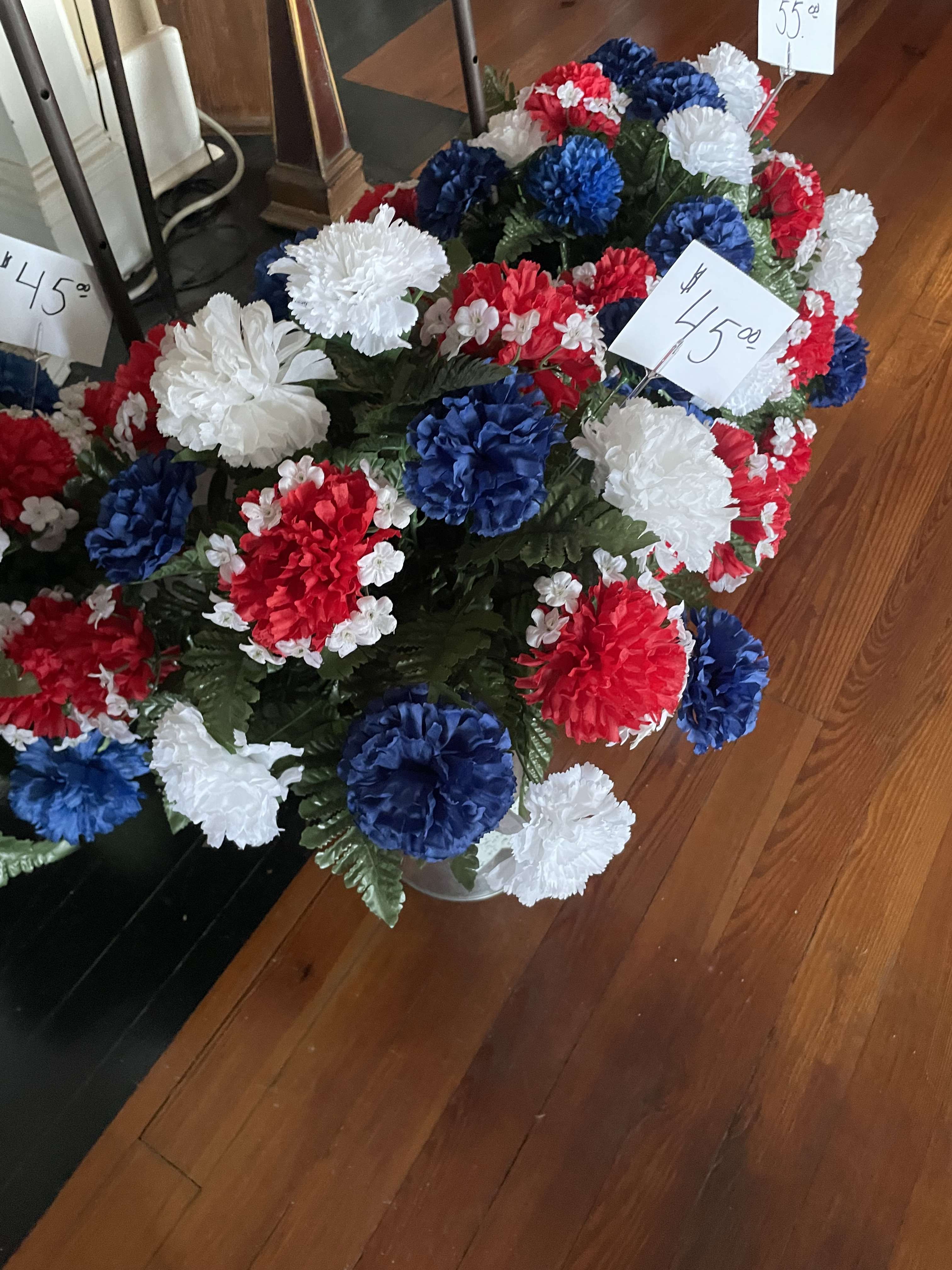 Red, white, and blue carnation arrangement in a vase