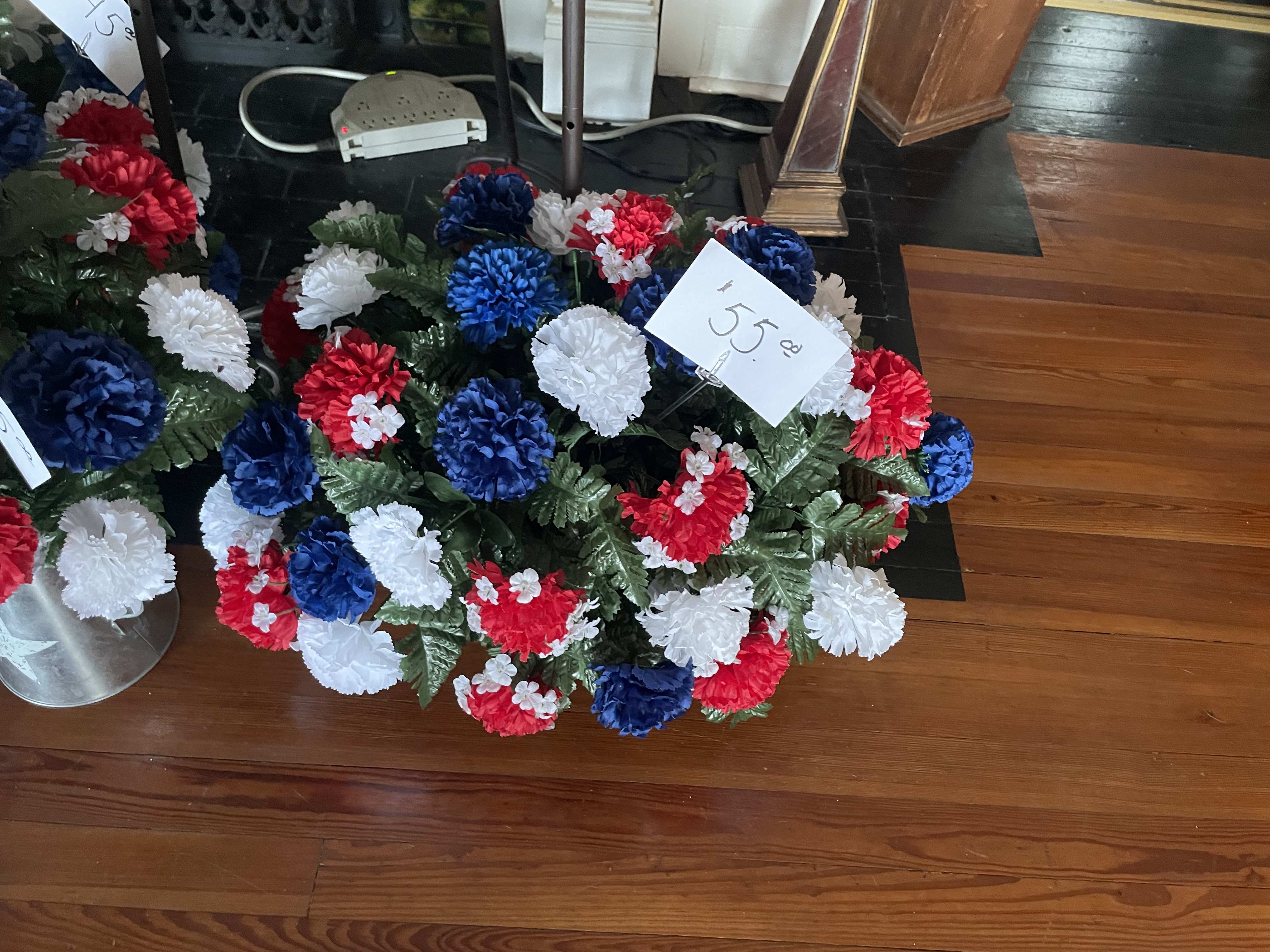 Memorial Patriotic Cemetery Saddle - A saddle of flowers in patriotic colors  This is a saddle for a cemetery rock. Can be put on a stand for funeral services. 