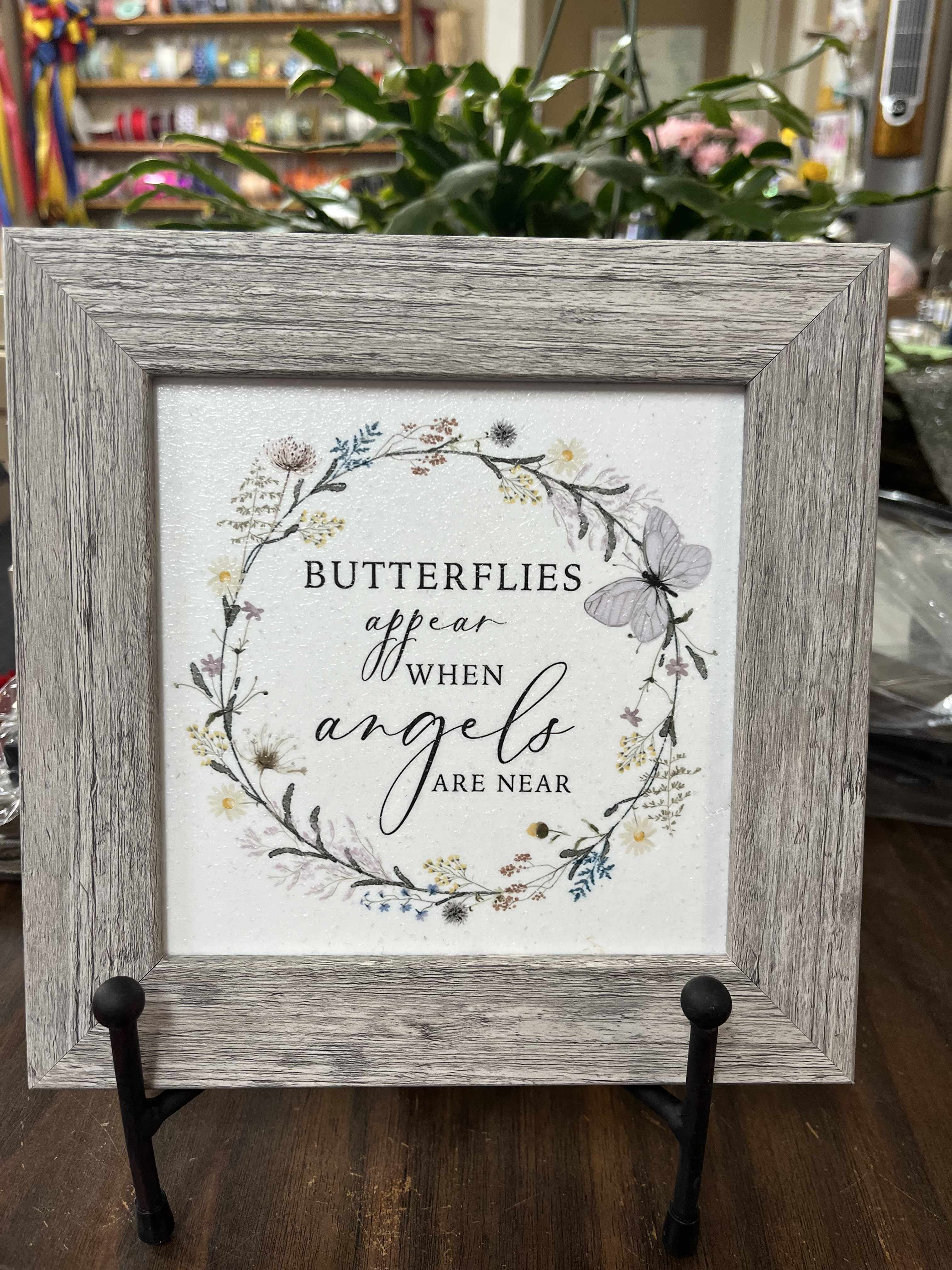 Framed sign with butterflies and the words "butterflies appear when angels are near"