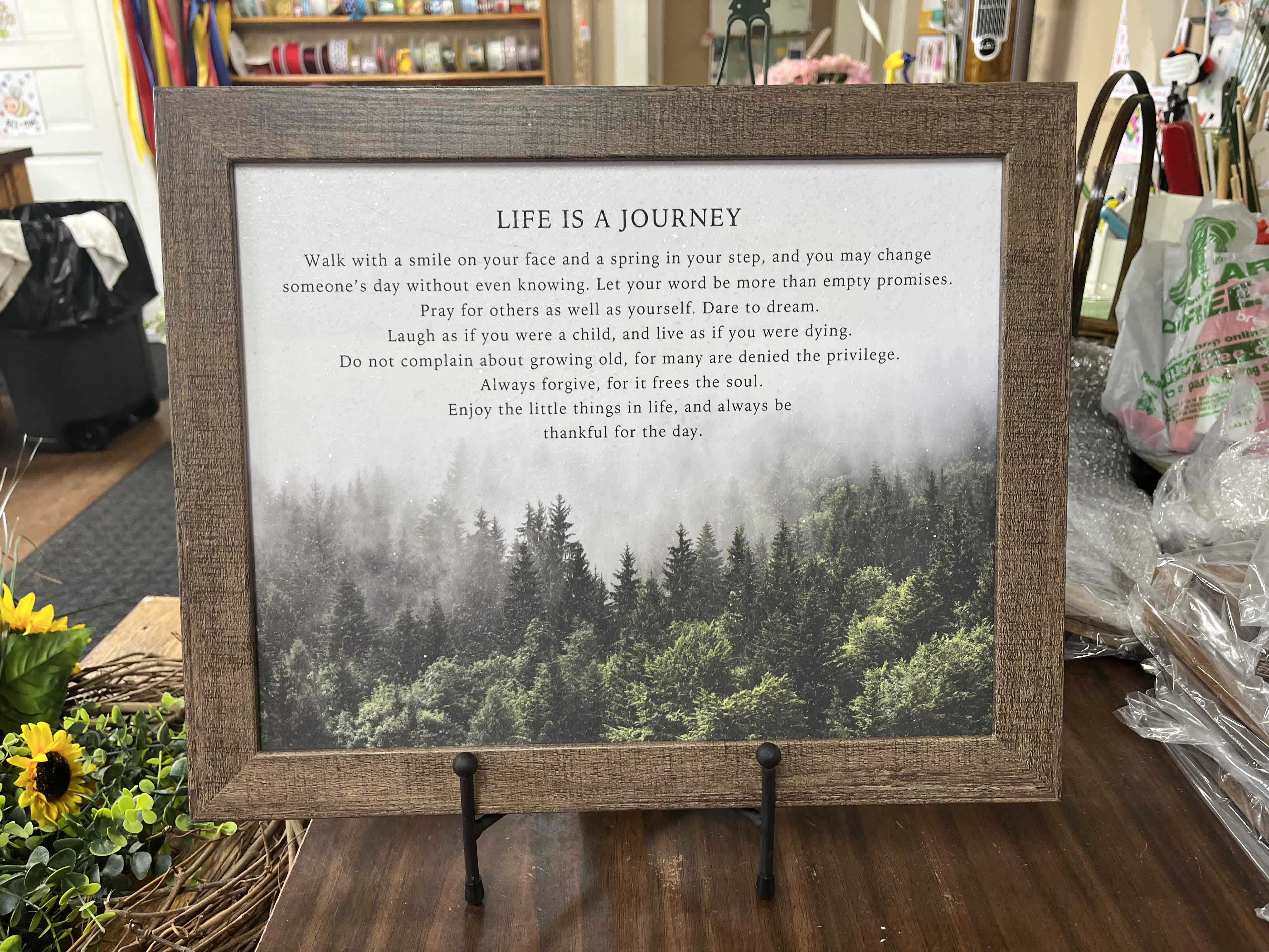 Framed inspirational quote print with a forest landscape