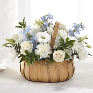 White and blue flowers arranged in a woven basket