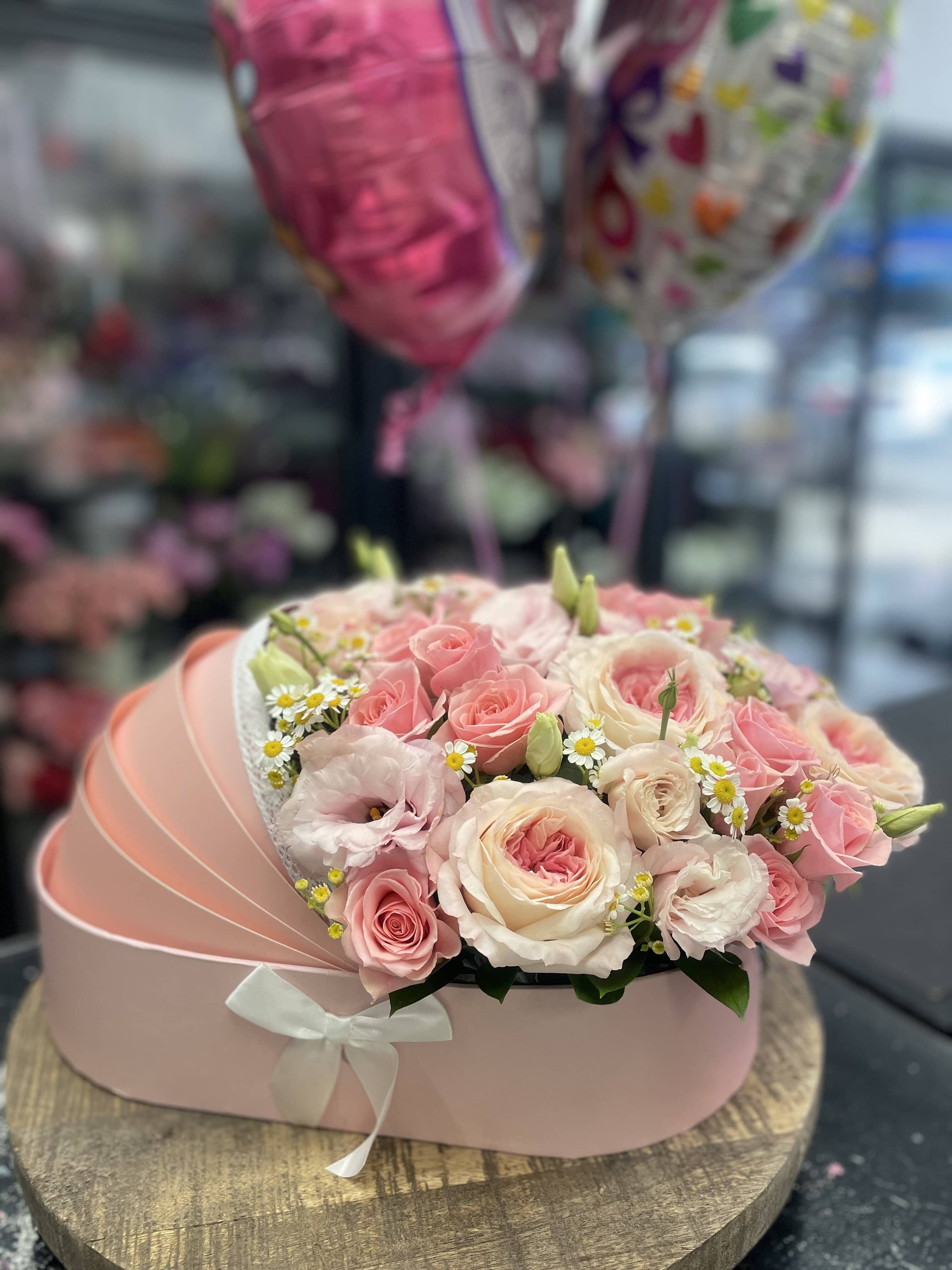 Pink and cream rose bouquet in a pastel hat box with a ribbon