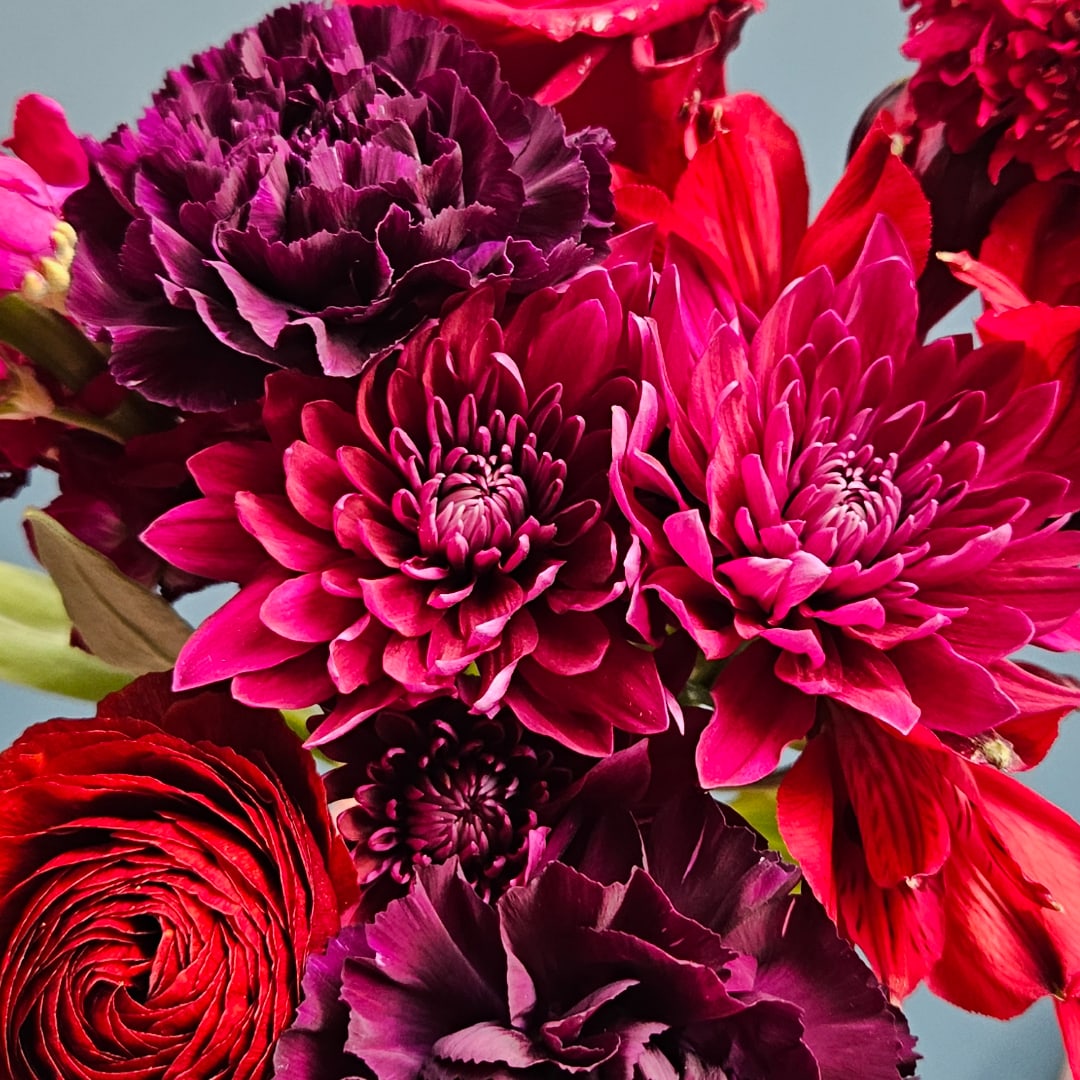Close-up of red and magenta flowers in a bouquet