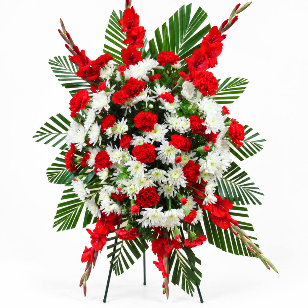Red and white floral standing spray with palm fronds on a stand