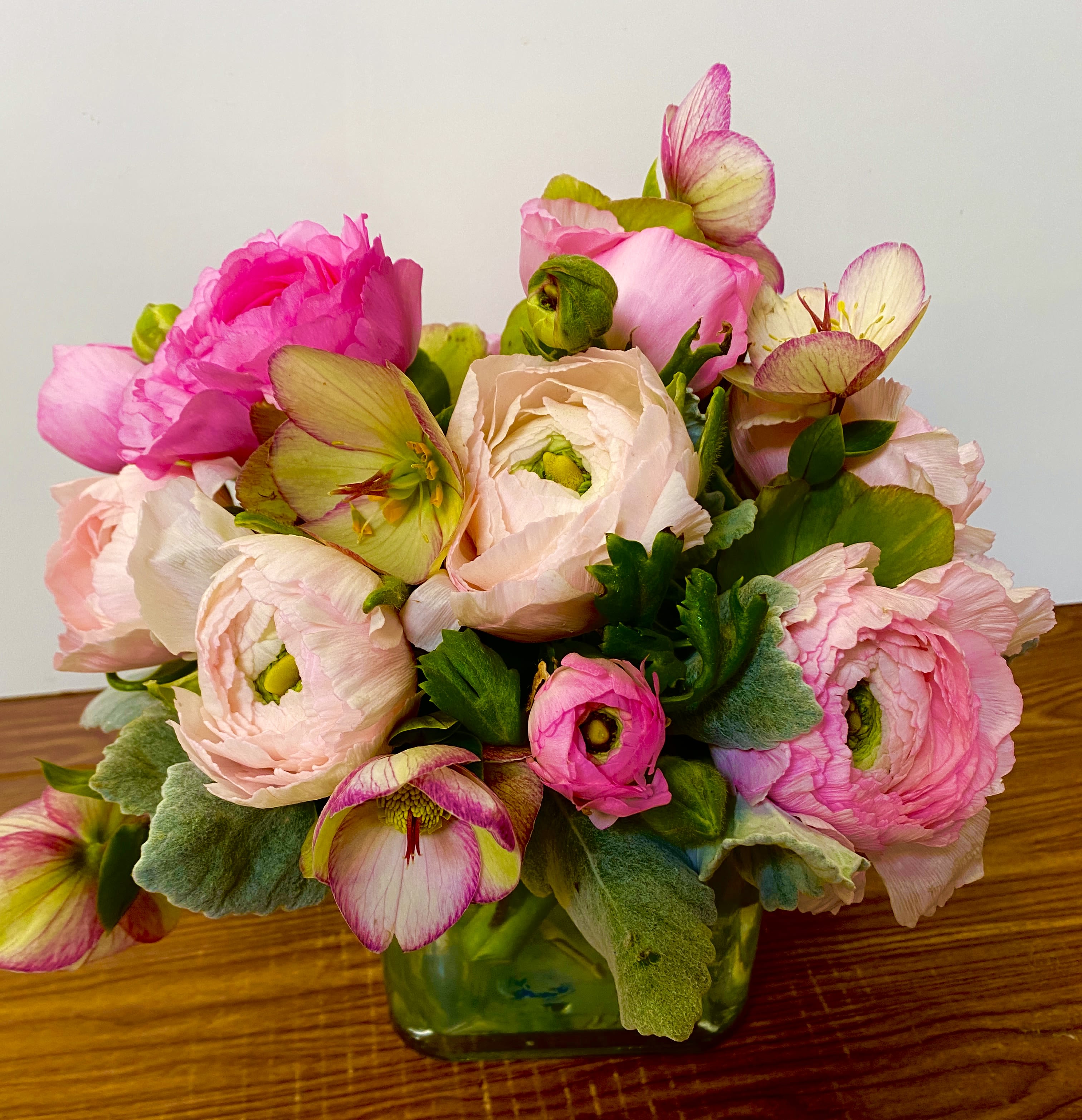 Pink and cream ranunculus bouquet in a glass vase