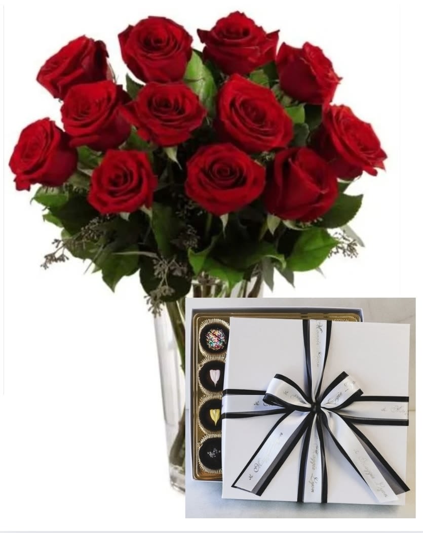 Bouquet of red roses in a clear vase with a box of chocolates