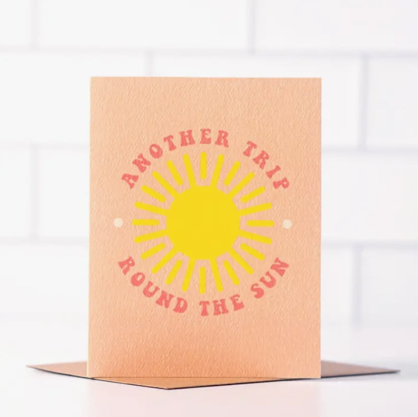 Peach card with a yellow sun and the words "Another Trip Around the Sun"