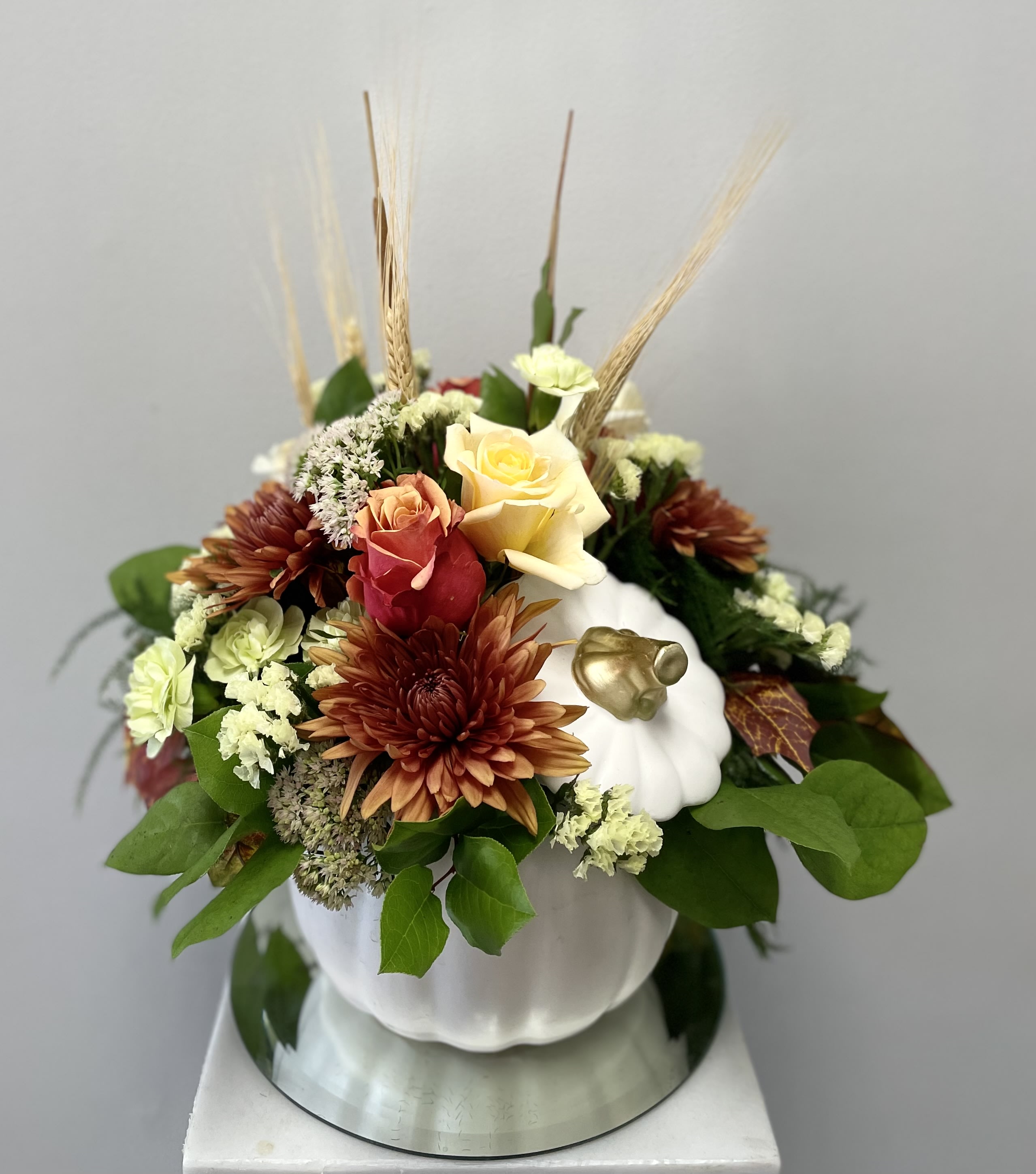 Allspice pumpkin bouquet - This beautiful autumnal design is created in a ivory ceramic pumpkin incorporating a bounty of fall flowers.