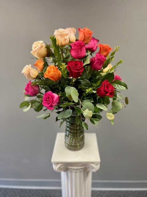Hearts On Fire - Two dozen mixed color roses arranged in a tall clear glass vase with lush greens. Colors may vary depending on availability. If there is a color combination you prefer or a color you wish to avoid please indicate that in the notes section of your order or please call the store.