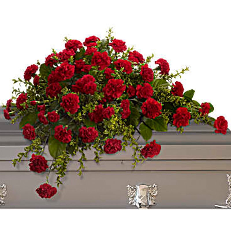 Adoration Half Casket Cover - With dignity and grace, brilliant red carnations express the depth of your heartfelt feelings, and the tenderness of your everlasting devotion. A classic half-couch spray of red carnations set against oregonia and salal, perfectly fitting for an open or closed casket service.