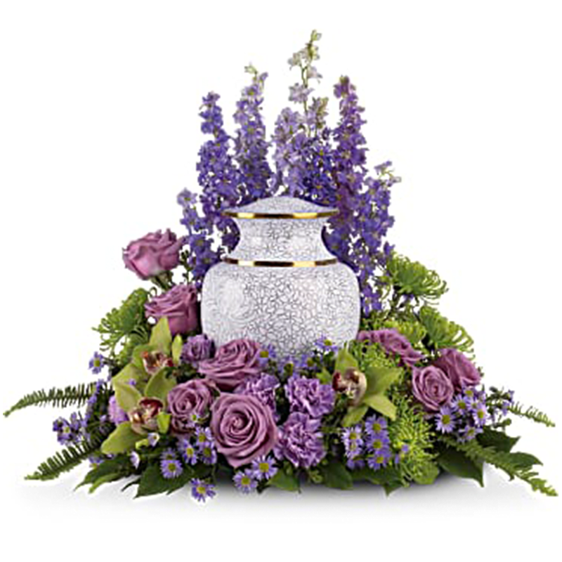 Purple floral arrangement around a white urn vase