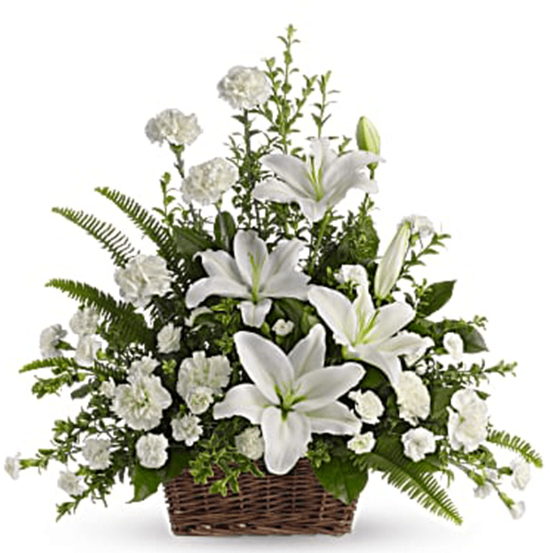 White lilies and carnations in a wicker basket