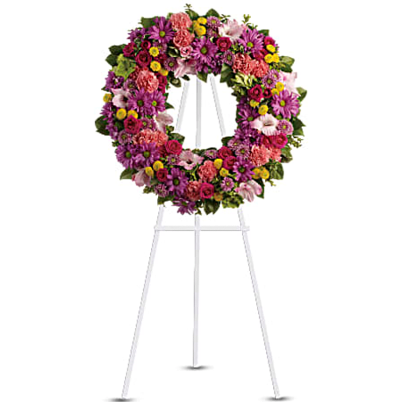 Ringed by Love Wreath Standing Spray - Memories of brighter days will offer solace and hope to the bereaved, as this vibrant multi-colored wreath expresses your caring and compassion during a time of mourning. A standing wreath includes vivid flowers such as green hydrangea, hot pink spray roses, pink gladioli and carnations, lavender and yellow chrysanthemums, all accented by bright greenery. Orientation: One-Sided