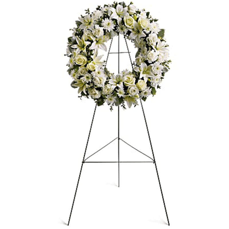 White floral wreath on a metal easel