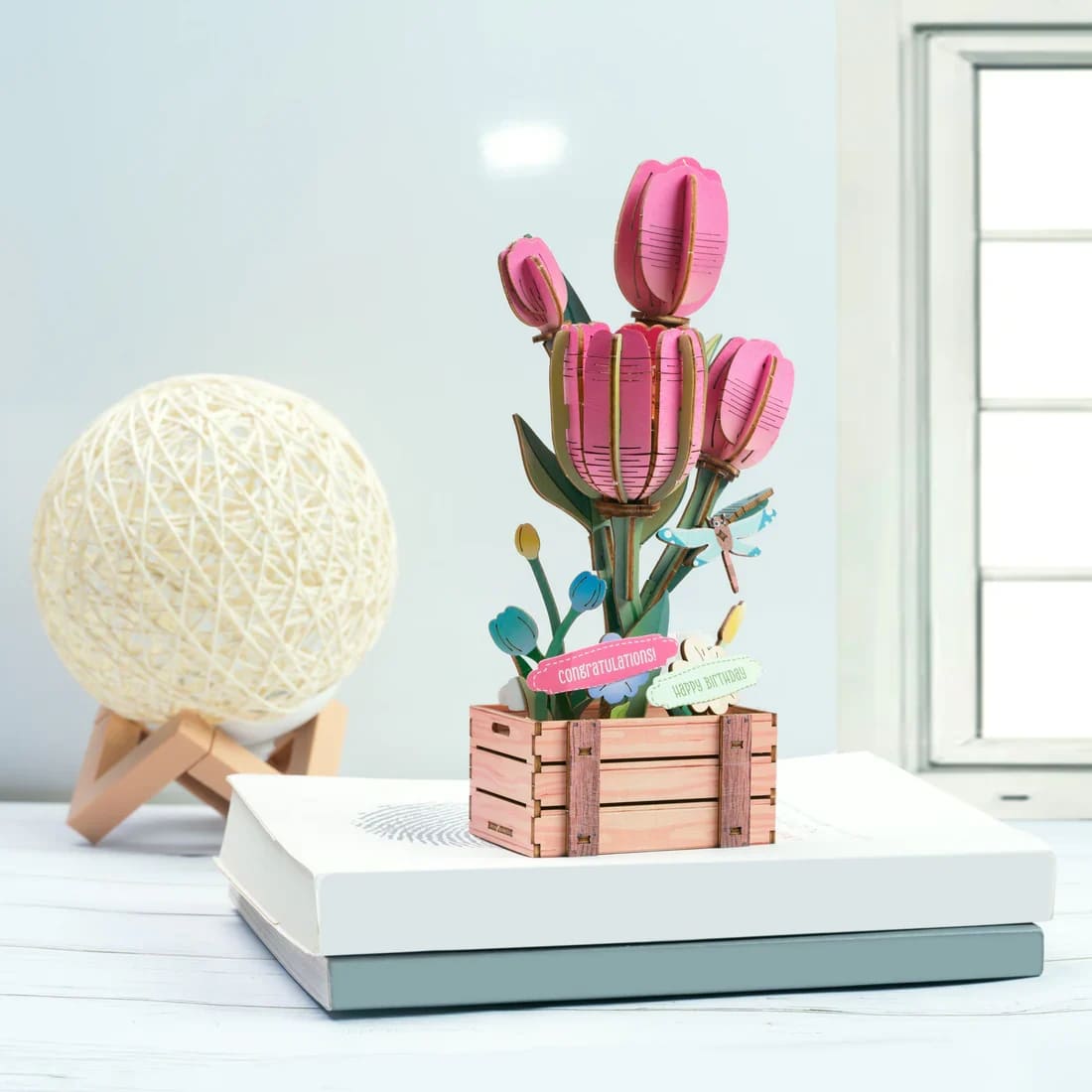 Hands Craft - Tulip Wooden 3D Puzzle - Bring simple elegance to your space with this DIY miniature Tulip Bloom wooden puzzle. Inspired by the tulip's smooth, cup-shaped petals and clean lines, this design highlights the flower's timeless beauty. Each precision-cut wooden piece fits together easily without glue or tools, making assembly both relaxing and satisfying.  As the tulip takes shape, it becomes a charming decorative accent-perfect for desks, shelves, or as a thoughtful handmade gift.  The set also includes interchangeable message signs such as “I Love You,” “Happy Birthday,” “Congratulations,” and “Thank You,” allowing you to customize the display to suit the occasion and create a thoughtful, personal gift.  Age Range: 14+  Assembled Dimensions: 4.9 x 3.5 x 8.27 inches  Assembly Time: 2 hours  Piece Count: 75 pieces