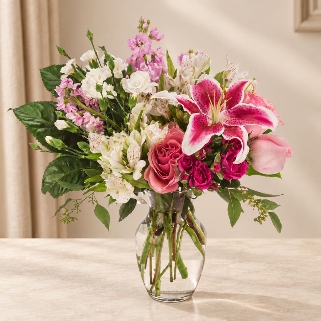 Pink and white mixed bouquet in a clear glass vase
