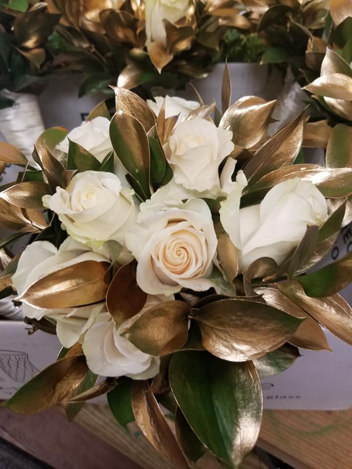 White rose bouquet with metallic gold leaves