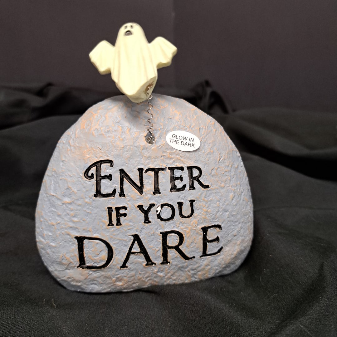 Ghost figurine on a painted stone with "Enter if you dare" text