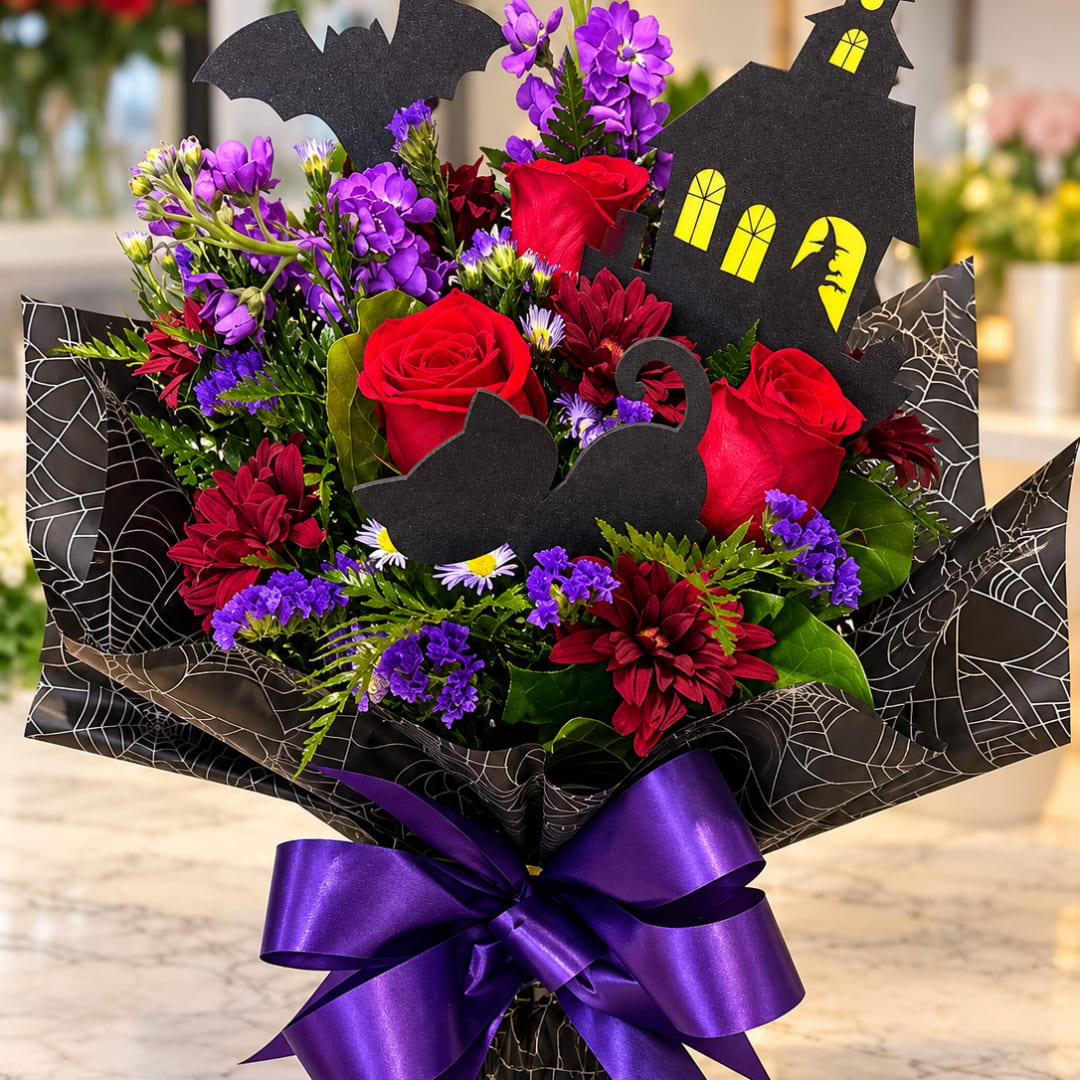 Halloween bouquet with red roses, purple flowers, and black house cutouts
