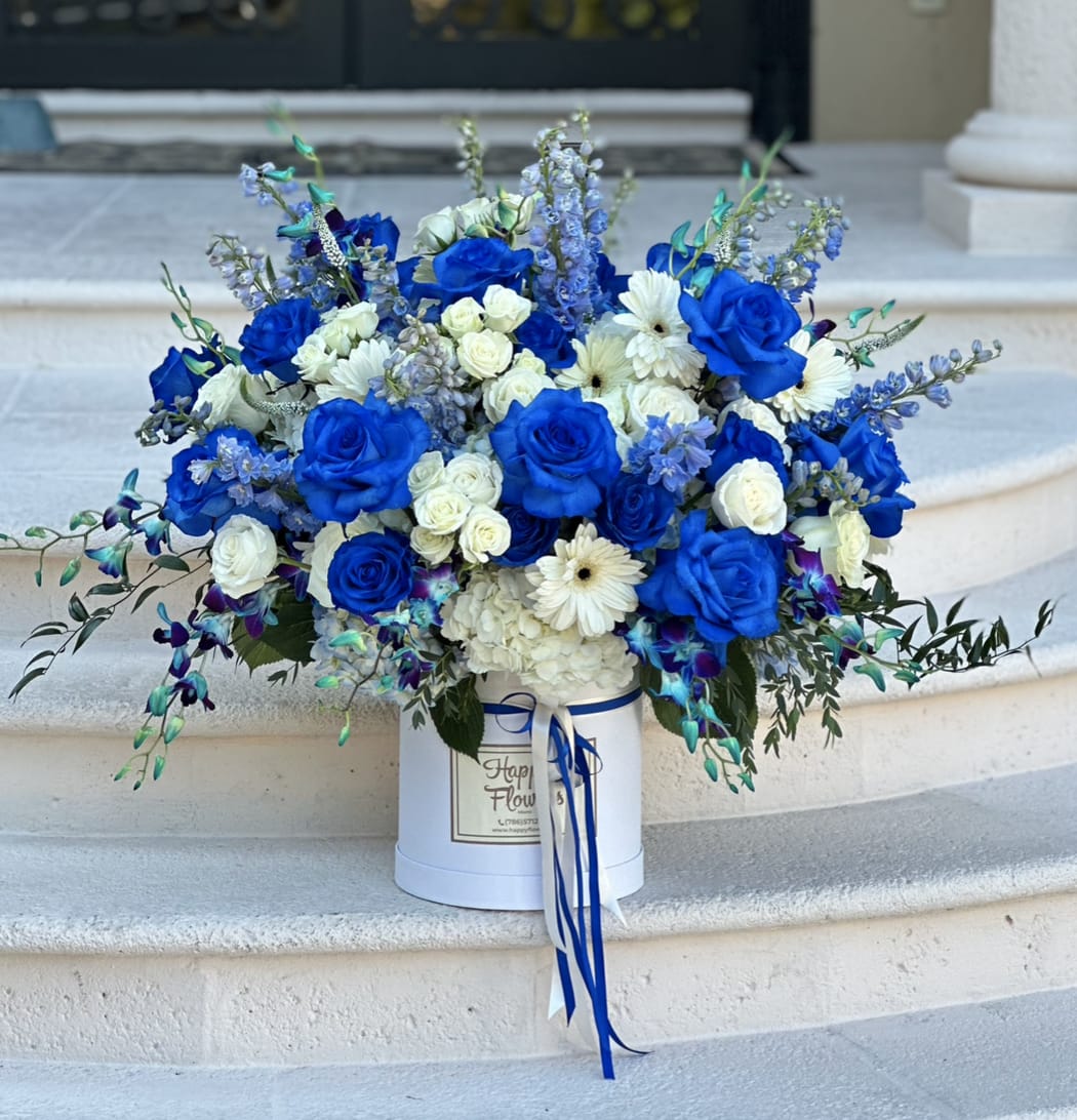Blue and white rose bouquet in a white hat box with ribbon