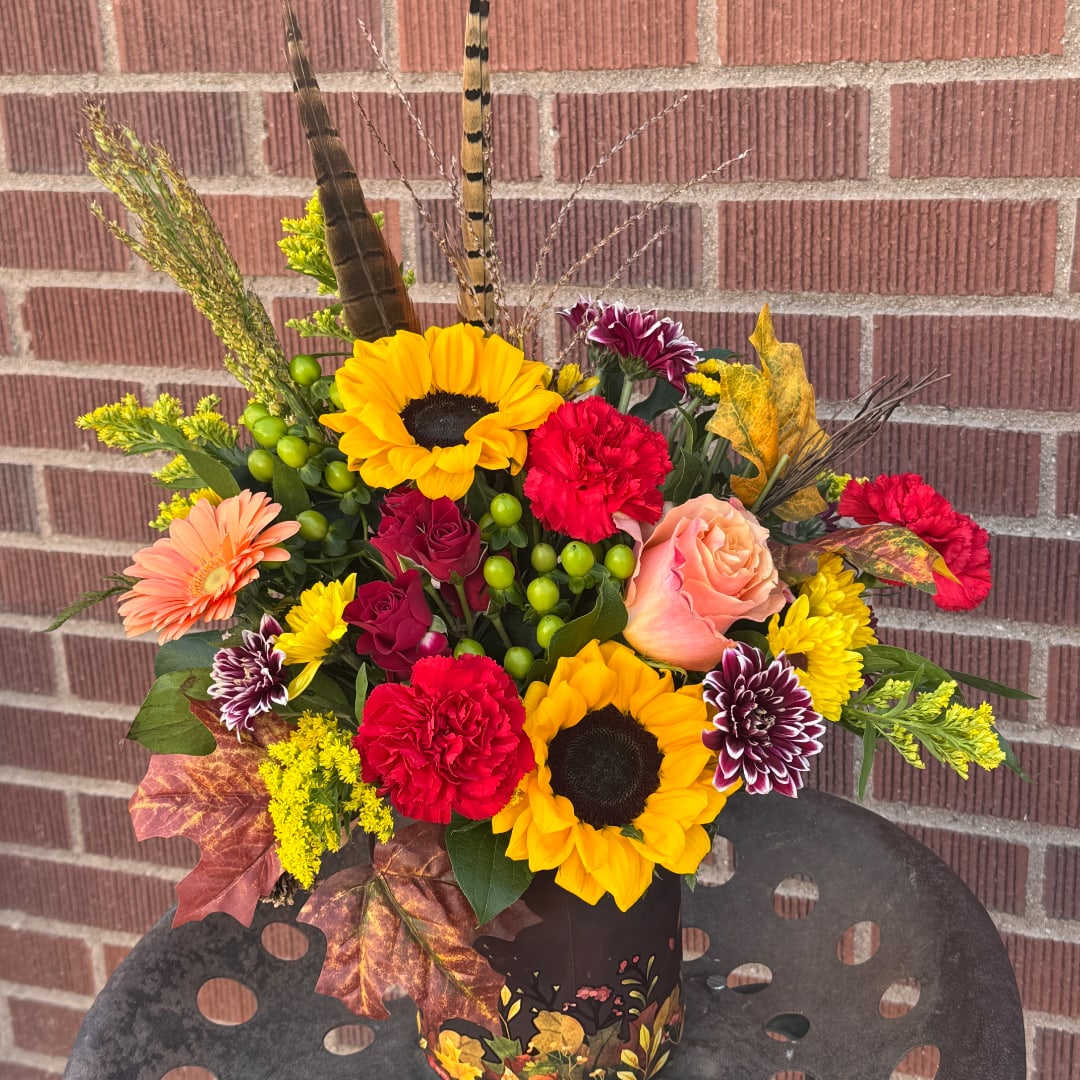 Autumn bouquet with sunflowers, roses, carnations, and mums in a decorative vase